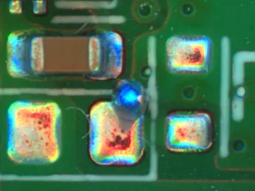 Solder ball on a pad beside a mounted component