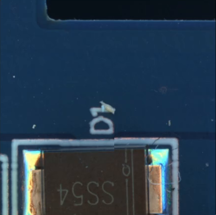 Small fragment on bare laminate above a mounted component